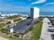 Aerial view of parking lot and landscaping with ocean and building in background at 3405 S Atlantic Ave # 501, New Smyrna Beach, FL 32169