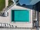 Aerial shot of a pool with lounge chairs and the ocean in the background at 3405 S Atlantic Ave # 501, New Smyrna Beach, FL 32169