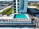 Overhead view of a pool with building and beachfront in the background at 3405 S Atlantic Ave # 501, New Smyrna Beach, FL 32169