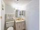 Bathroom with toilet, sink, and mirrored medicine cabinet at 3606 S Peninsula Dr # 809, Port Orange, FL 32127