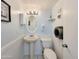 Small half bathroom with pedestal sink and toilet at 3606 S Peninsula Dr # 809, Port Orange, FL 32127