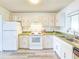 Bright kitchen featuring white cabinets and green countertops at 3606 S Peninsula Dr # 809, Port Orange, FL 32127