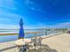 Relaxing waterfront deck with table, chairs, and umbrella at 3606 S Peninsula Dr # 809, Port Orange, FL 32127