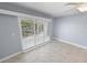 Living room with sliding doors and plantation shutters at 3641 S Atlantic Ave # 221, Daytona Beach, FL 32118