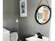 Small bathroom with sink, toilet, and mirror at 402 Lincoln Ave, New Smyrna Beach, FL 32169