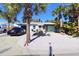 Landscaped front yard with palm trees and parking area at 402 Lincoln Ave, New Smyrna Beach, FL 32169