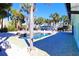 Expansive pool area with palm trees and patio at 402 Lincoln Ave, New Smyrna Beach, FL 32169