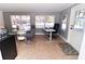 Bright sunroom with dining table and home office space at 402 Lincoln Ave, New Smyrna Beach, FL 32169