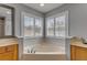 Bright bathroom features a large soaking tub and dual windows offering an abundance of natural light at 454 Venetian Villa Dr, New Smyrna Beach, FL 32168