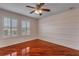 Bedroom with hardwood floors, ceiling fan and natural light at 454 Venetian Villa Dr, New Smyrna Beach, FL 32168