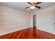 This bedroom has hardwood floors, en suite closet, ceiling fan and ample natural light at 454 Venetian Villa Dr, New Smyrna Beach, FL 32168