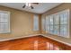 Comfortable bedroom showcasing hardwood floors, neutral paint, and plantation shutters for a bright, welcoming space at 454 Venetian Villa Dr, New Smyrna Beach, FL 32168