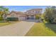 Charming two-story home showcasing a paved driveway, two-car garage, and manicured landscaping at 454 Venetian Villa Dr, New Smyrna Beach, FL 32168