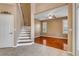 Foyer featuring tile floors and staircase with wood steps and white risers at 454 Venetian Villa Dr, New Smyrna Beach, FL 32168