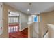 Upstairs hallway with hardwood floors and natural light at 454 Venetian Villa Dr, New Smyrna Beach, FL 32168