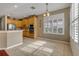 Bright kitchen featuring stainless steel appliances, tile flooring, and plantation shutters for natural light at 454 Venetian Villa Dr, New Smyrna Beach, FL 32168