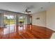 Spacious living room featuring hardwood floors and sliding doors to the patio at 454 Venetian Villa Dr, New Smyrna Beach, FL 32168