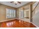 Living room featuring hardwood floors, plantation shutters, and staircase view at 454 Venetian Villa Dr, New Smyrna Beach, FL 32168