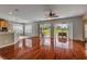 Bright living room with hardwood floors and sliding glass doors to outdoor living at 454 Venetian Villa Dr, New Smyrna Beach, FL 32168