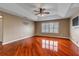 Primary bedroom boasts hardwood floors, en suite bath, ceiling fan and plantation shutters on the windows at 454 Venetian Villa Dr, New Smyrna Beach, FL 32168