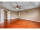 Bright and airy main bedroom with hardwood floors, tray ceilings, ceiling fan and en suite bath at 454 Venetian Villa Dr, New Smyrna Beach, FL 32168