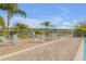 Community pool area featuring ample seating and lounge chairs with views of a serene lake at 454 Venetian Villa Dr, New Smyrna Beach, FL 32168