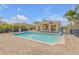 Community pool with a covered area that includes tables and chairs for resident use at 454 Venetian Villa Dr, New Smyrna Beach, FL 32168