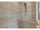 Walk-in shower with floor-to-ceiling tile and rainfall shower head at 454 Venetian Villa Dr, New Smyrna Beach, FL 32168