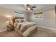 Cozy bedroom with a striped comforter and ceiling fan at 4611 Doris Dr, New Smyrna Beach, FL 32169