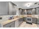 Modern kitchen with gray cabinets and granite countertops at 4611 Doris Dr, New Smyrna Beach, FL 32169