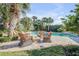 Enjoy this private pool area with patio furniture at 4611 Doris Dr, New Smyrna Beach, FL 32169