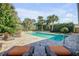 Spacious pool area with lounge chairs and lush landscaping at 4611 Doris Dr, New Smyrna Beach, FL 32169