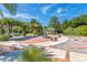 Landscaped garden with pergola, fountain, and benches at 4623 Rivers Edge Village Ln # 6204, Ponce Inlet, FL 32127