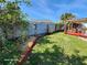 Landscaped backyard with fence, bird feeder and garden at 4650 Saxon Dr, New Smyrna Beach, FL 32169