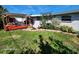 Landscaped backyard with deck and pergola at 4650 Saxon Dr, New Smyrna Beach, FL 32169