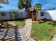 Landscaped backyard with a shed and brick pathway at 4650 Saxon Dr, New Smyrna Beach, FL 32169