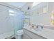 Bright bathroom featuring a shower, vanity, and tile walls at 4650 Saxon Dr, New Smyrna Beach, FL 32169