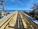 Wooden boardwalk leading to a beautiful sandy beach at 4650 Saxon Dr, New Smyrna Beach, FL 32169