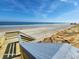 Beachfront view with stairs leading down to the sand at 4650 Saxon Dr, New Smyrna Beach, FL 32169