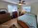 Bedroom with wood floors, ceiling fan, and built-in desk at 4650 Saxon Dr, New Smyrna Beach, FL 32169