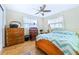 Bright bedroom featuring wood floors, natural light, and a comfortable bed at 4650 Saxon Dr, New Smyrna Beach, FL 32169