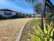 Gravel driveway and landscaping leading to a ranch-style home at 4650 Saxon Dr, New Smyrna Beach, FL 32169