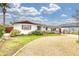 Charming single-story home with gravel driveway, manicured lawn, and beautifully landscaped front yard at 4650 Saxon Dr, New Smyrna Beach, FL 32169