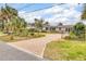 Charming home showcasing a brick driveway, manicured landscaping, and wrought iron fence surrounding the front yard at 4650 Saxon Dr, New Smyrna Beach, FL 32169