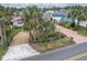 Street view of a charming home with brick driveway, tropical landscaping, and manicured front yard at 4650 Saxon Dr, New Smyrna Beach, FL 32169