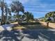 Front yard view of house with palm trees and driveway at 4650 Saxon Dr, New Smyrna Beach, FL 32169