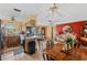 Open-concept kitchen with wood cabinets, breakfast bar, and tile flooring adjoining the living area at 4650 Saxon Dr, New Smyrna Beach, FL 32169