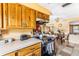 Functional kitchen featuring wood cabinetry, modern appliances, and seamless access to the dining area at 4650 Saxon Dr, New Smyrna Beach, FL 32169