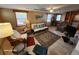 Cozy living room featuring wood furniture, a large TV, and tiled floors at 4650 Saxon Dr, New Smyrna Beach, FL 32169