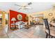 Cozy living room featuring tile flooring, ceiling fans, and seamless access to the adjoining rooms at 4650 Saxon Dr, New Smyrna Beach, FL 32169